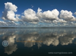 Water Reflections Of A Cumulonimbus Cloudscape.