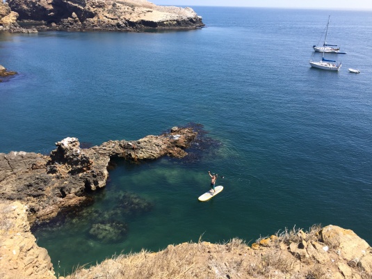 Little Scorpion anchorage. Behind the paddleboarder that rock outcrop extends another 25 yards out toward the boats so be careful anchoring in there. Where the boats are and ahead of them is sand bottom.