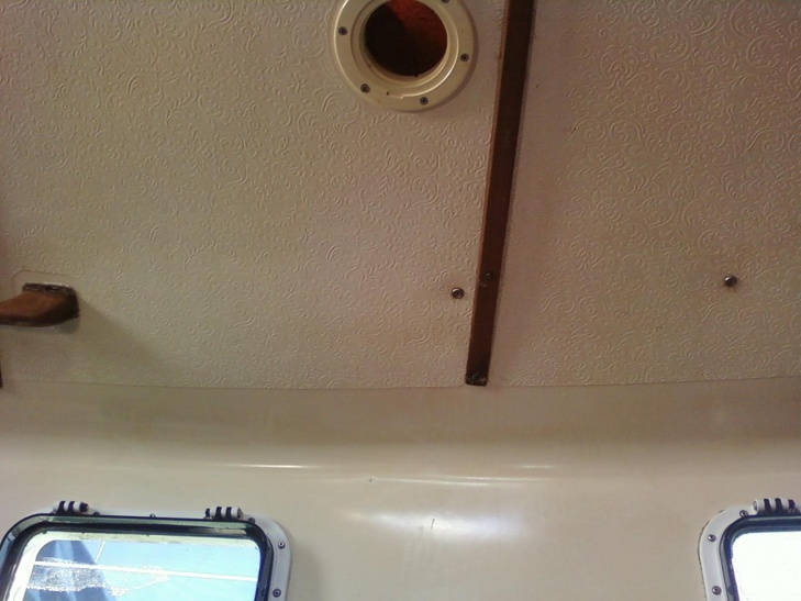 inside view. the two screws on the right line up above with forward handrail. The end of the interior handrail on the far left lines up with the aft handrail above.
