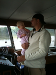 Jeff at the helm while holding Ellie:-)